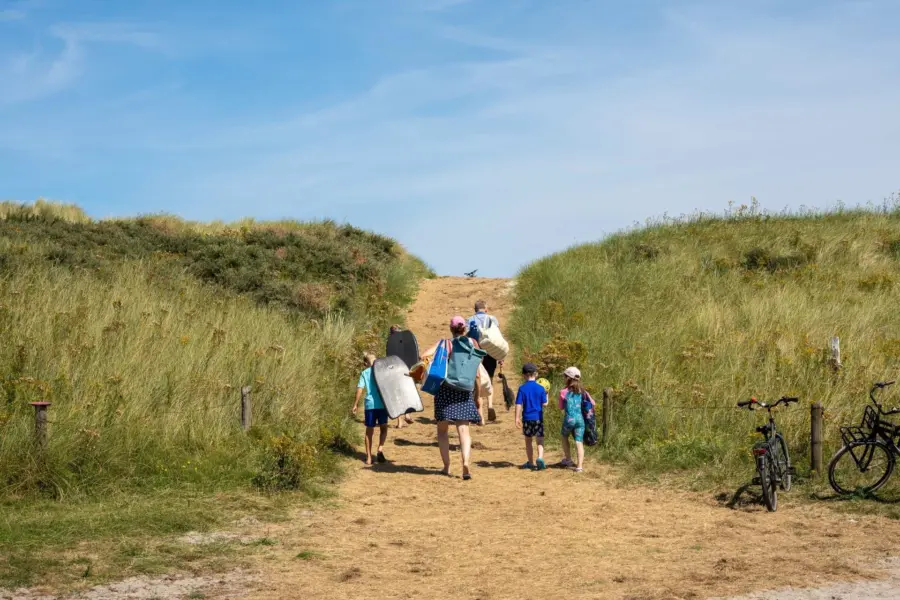 Gezin wandelen strandpad duinen Ameland